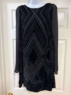 This black Express velvet mini dress features a geometric front pattern